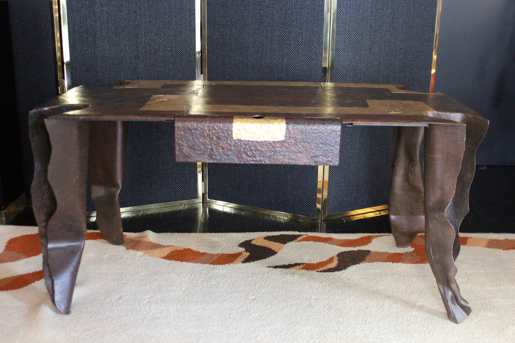 Scrivania scultorea d'artista J. Argueyrolles, in metallo patinato con forme organiche e cassetto testurizzato con accento dorato.

