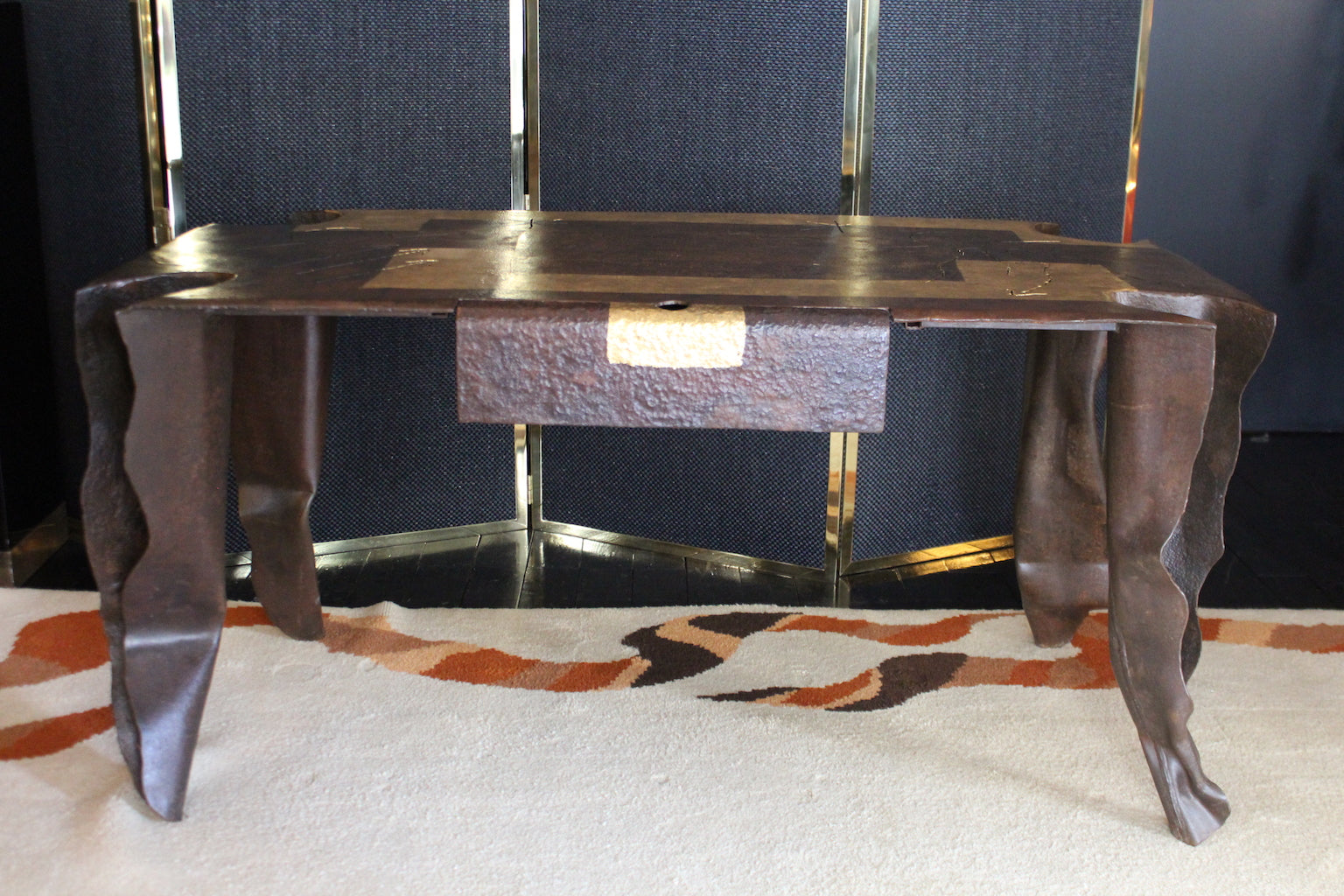 Scrivania scultorea d'artista J. Argueyrolles, in metallo patinato con forme organiche e cassetto testurizzato con accento dorato.

