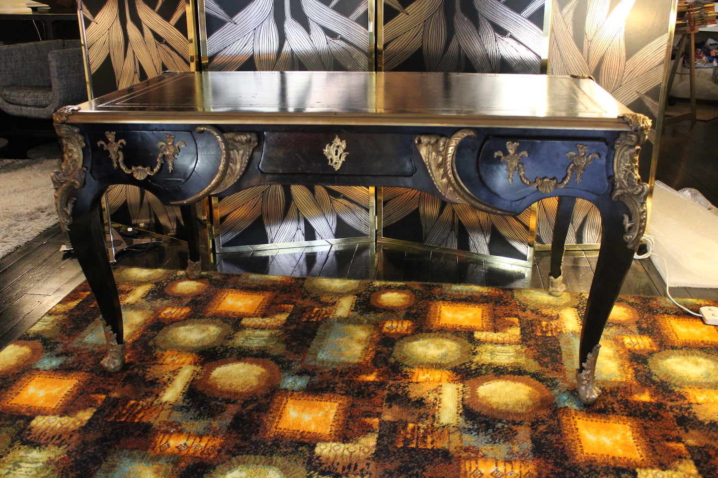 Scrivania antica stile Napoleone III, primi '900, in legno laccato nero con gambe cabriole e ricchi intarsi in ottone dorato.