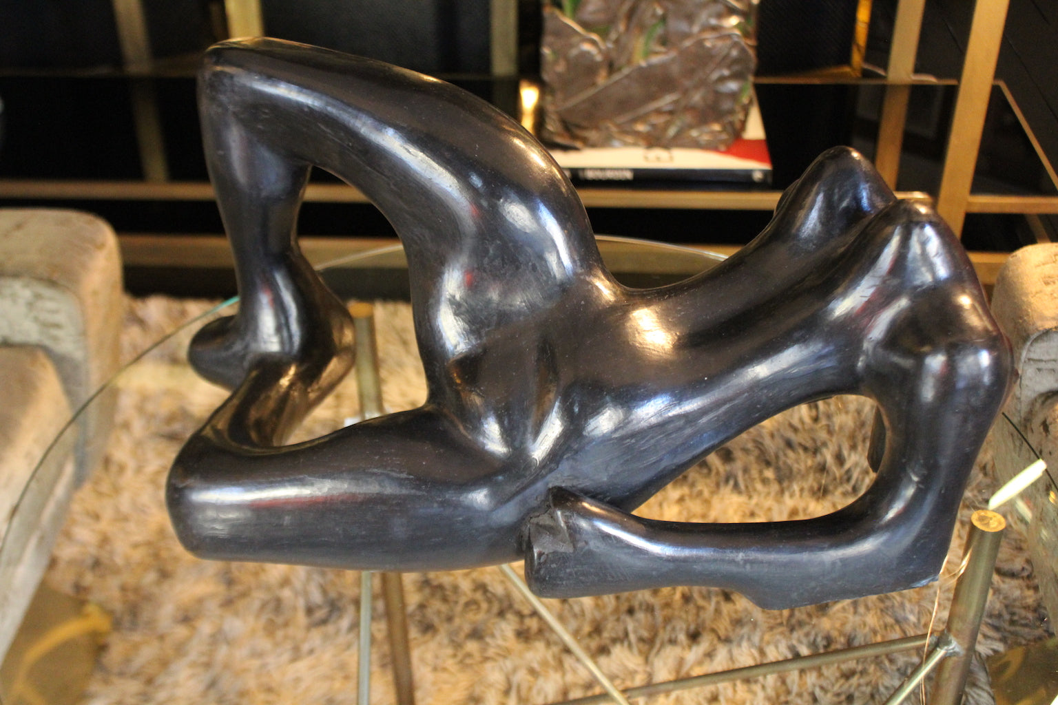 Scultura modernariato anni '50 in ceramica nera lucida, raffigurante una figura femminile astratta e reclinata.

